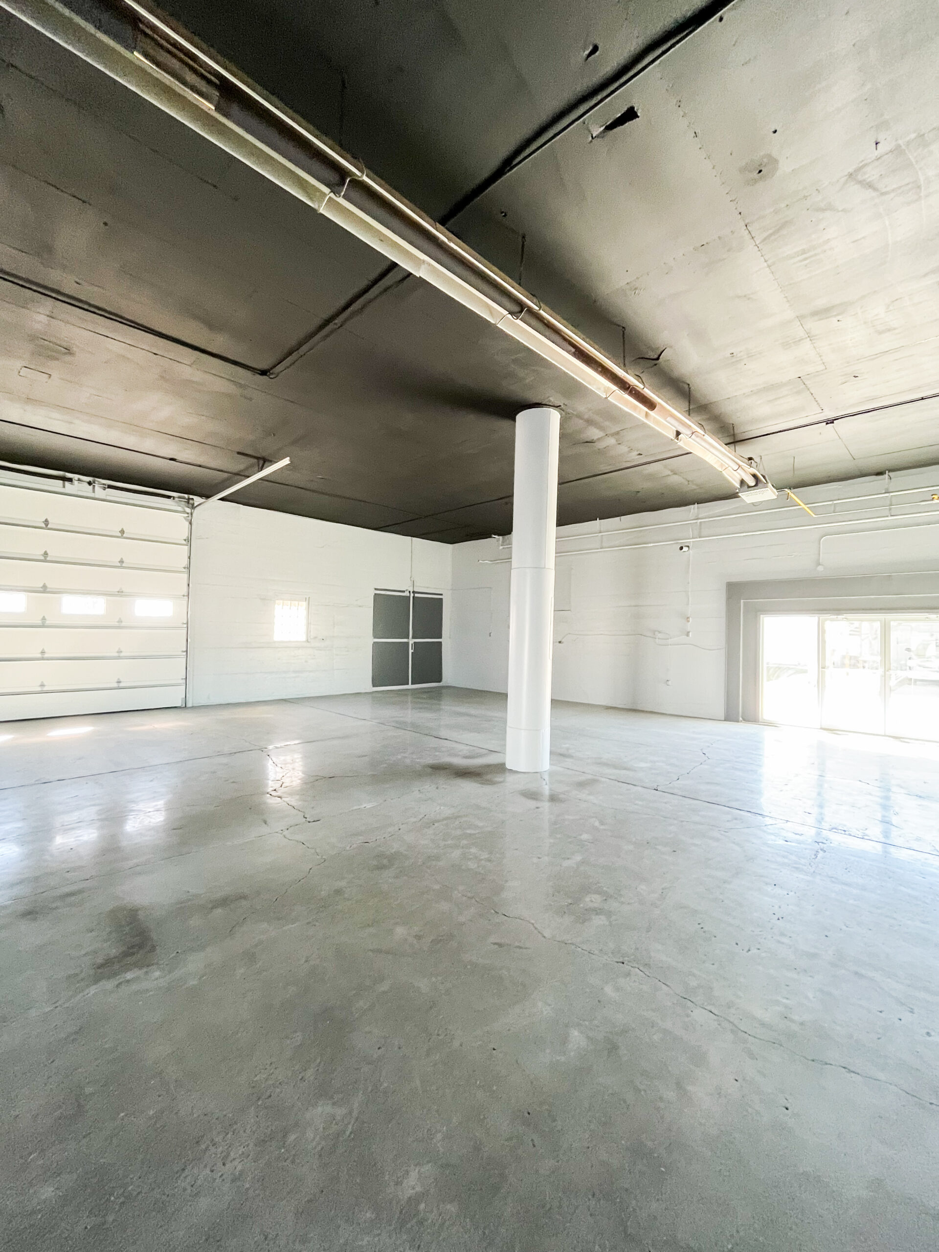Industrial building freshly painted black and white. After photos for Moonlight Painters